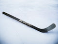 black mini hockey stick with the text "#99 Gretzky" printed on the shaft.